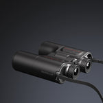 Black binoculars with 'Unistellar' branding on a dark background