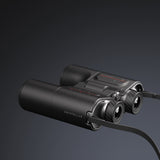 Black binoculars with 'Unistellar' branding on a dark background